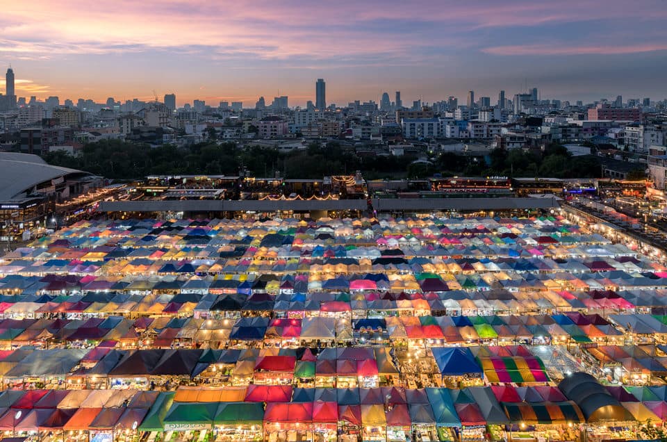 Colorful tents of the Old Train Night Market in Bangkok, Thailand at sunset