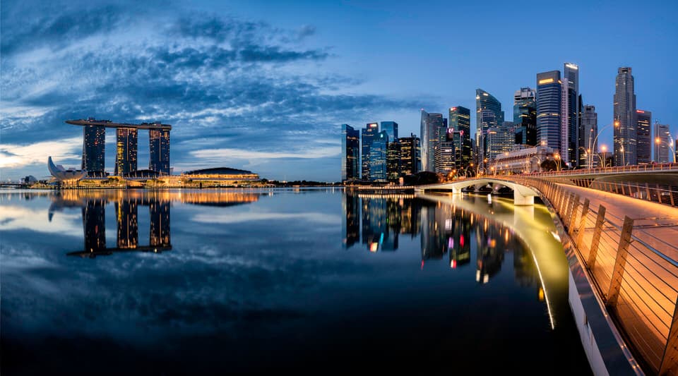 Singapore Marina Bay skyline at twilight with reflections in the water