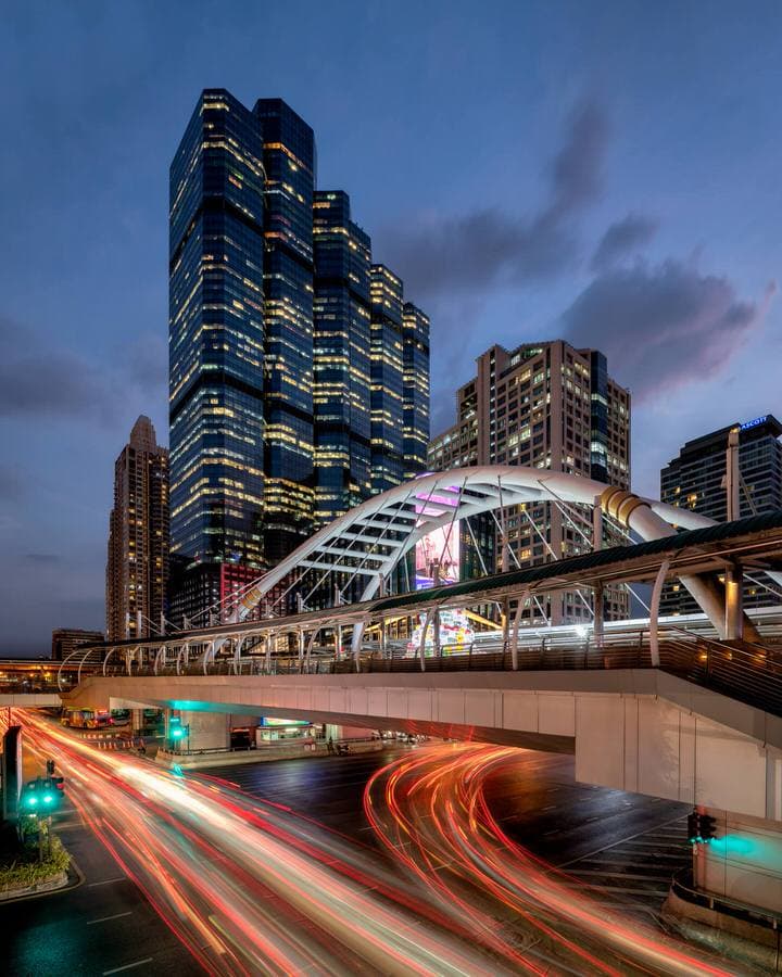 Night view of Sathorn Skywalk in Bangkok with light trails