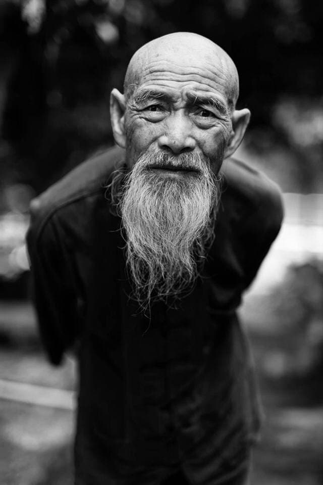 Close-up black-and-white portrait of a cormorant fisherman at home in Guilin, China.