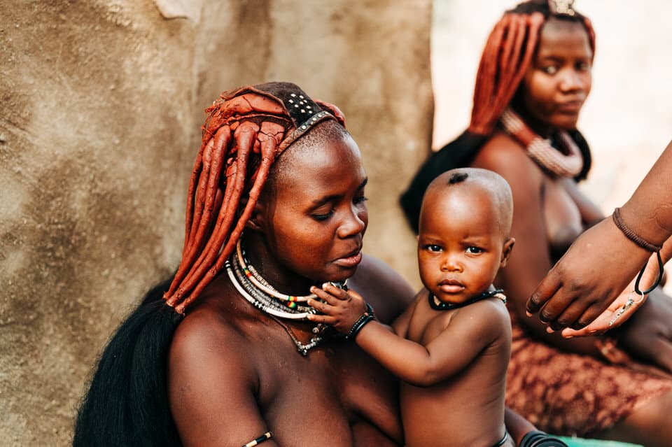 Himba mother holding her child in Namibia