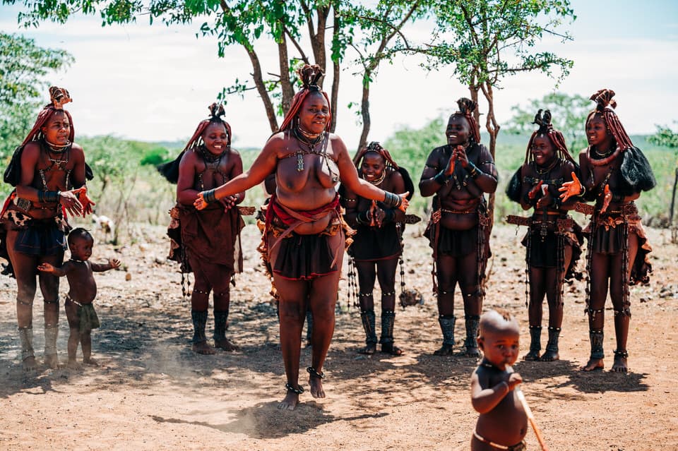 Himba woman dancing with her tribe in Namibia