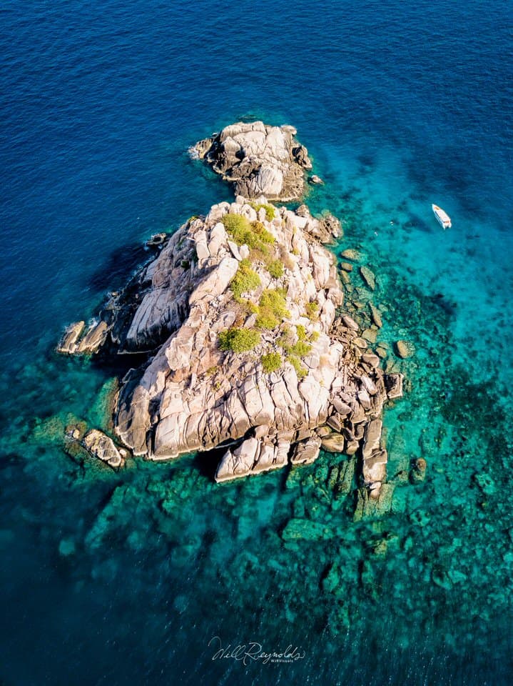 Aerial view of Shark Island surrounded by turquoise waters near Koh Tao, Thailand