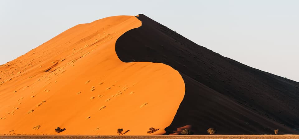 Dune 45 in Sossusvlei, Namibia, illuminated by sunrise with shadow contrasts