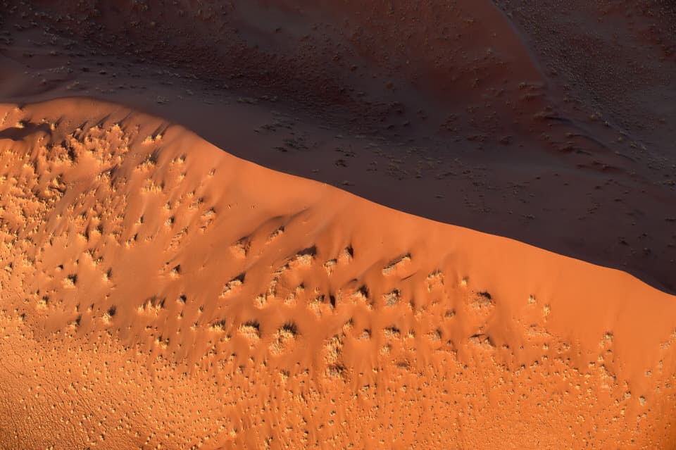 Close-up aerial view of sand dune textures and colors in Sossusvlei, Namibia