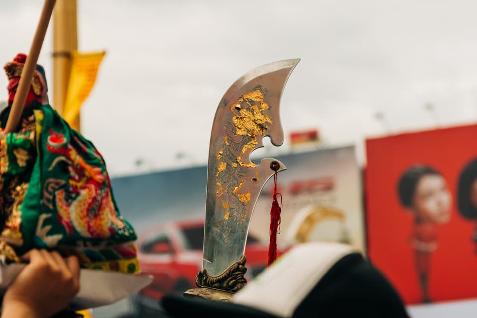 Devotee holding a ceremonial blade in the Phuket Vegetarian Festival.