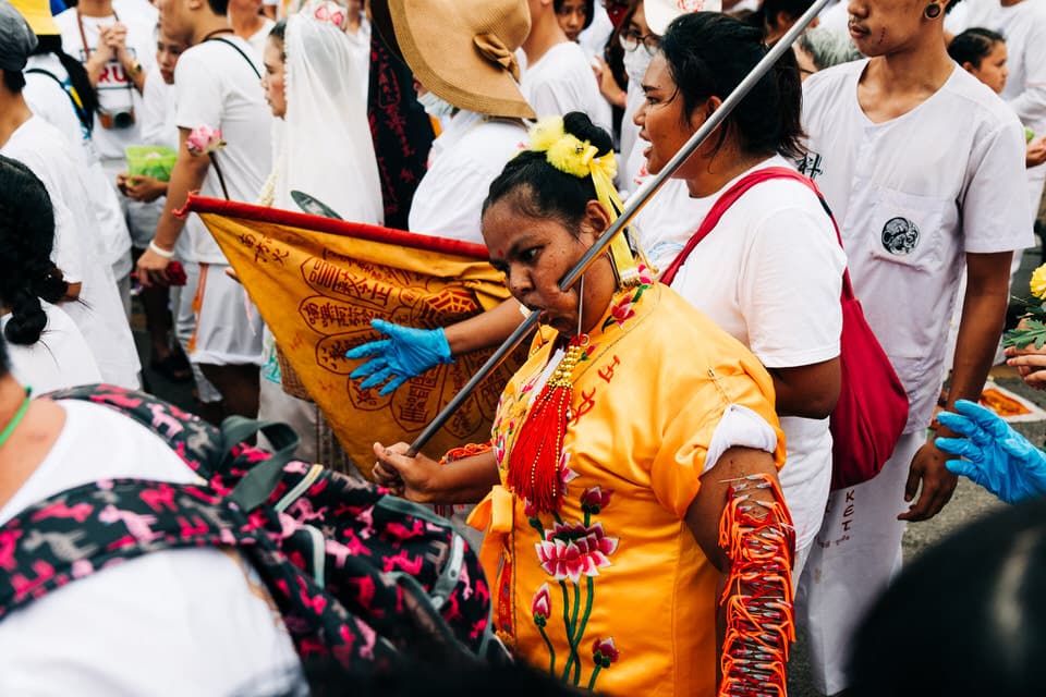 Procession with traditional umbrellas in Phuket Vegetarian Festival.