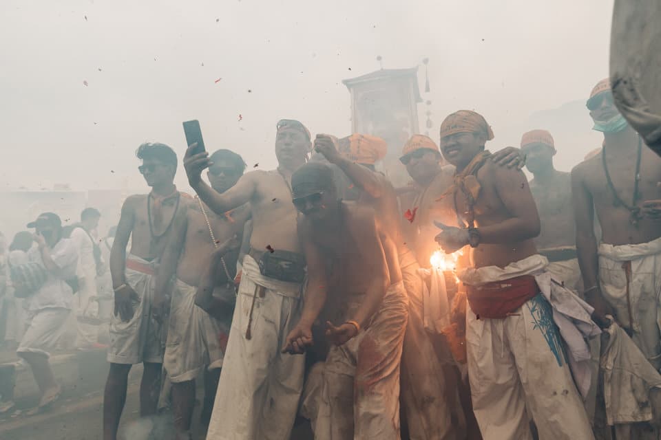 Procession with firecrackers at Phuket Vegetarian Festival.