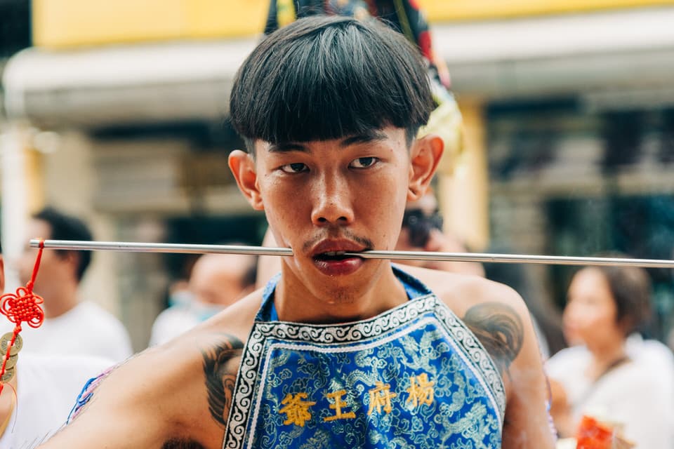 Devotee with facial piercings at Phuket Vegetarian Festival.