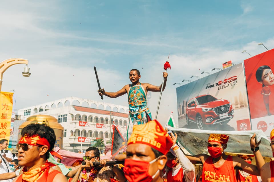 Performers during the Phuket Vegetarian Festival parade with a balancing act.